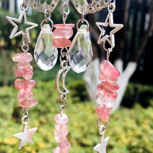 Close-up of celestial suncatcher with silver moon, stars, pink beads and crystal drop