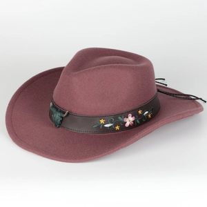 Detail of burgundy wool fedora featuring leather band with floral embroidery and bull head stud