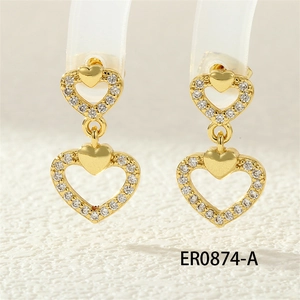 Detail of gold double heart earrings with white cubic zirconia and hollow frame design