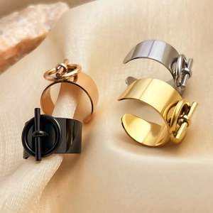 Set of four minimalist wide open rings in gold, silver, black and rose gold on silk