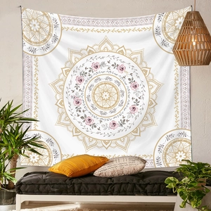 Detail of pink and beige mandala tapestry hanging above a boho style daybed with pillows