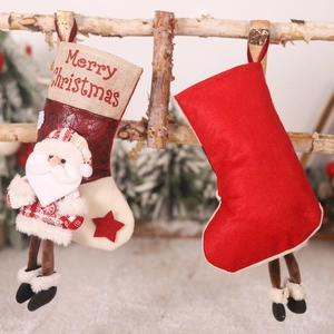 Hanging Christmas stocking with Santa doll decoration and Merry Christmas print