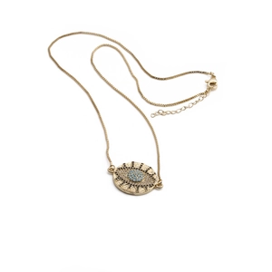 Detail of gold-plated evil eye pendant necklace with sparkling blue and clear crystals