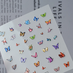 5D embossed butterfly nail art stickers with intricate floral patterns on a magazine background