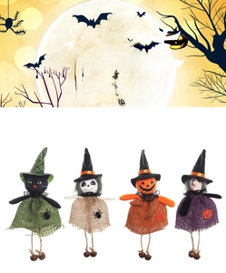 Close-up of four Halloween hanging dolls with witch hats and small metal bells