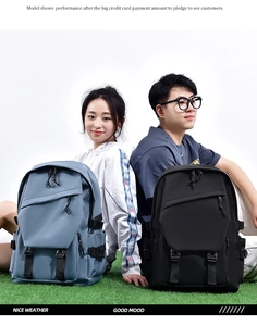 Blue and black travel backpacks with side mesh pockets worn by models on green grass