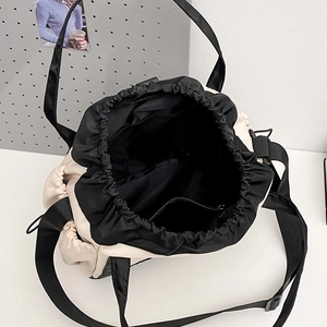 Versatile nylon tote bag with drawstring closure and star logo for travel or outdoor use