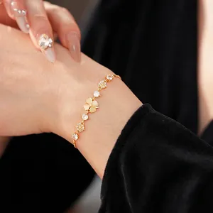 Gold plated bracelet featuring opal clover charms and sparkling zircon floral accents