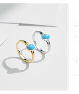 Macro shot of S925 sterling silver stamp and blue opal stones on minimalist rings