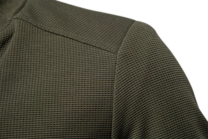 Detailed close-up of army green waffle knit fabric and shoulder stitching on a men jacket