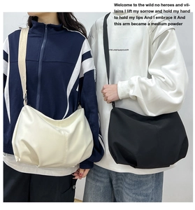 Detail showing contrasting off-white faux leather and black canvas crossbody dumpling bags