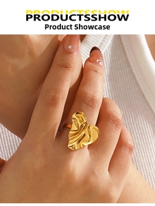 Detailed view of an irregular heart ring with gold plating and lava texture on a finger