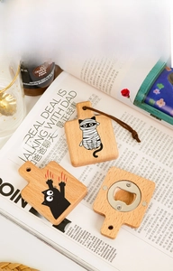 Detail showing creative cat-themed wooden bottle opener with leather hanging strap