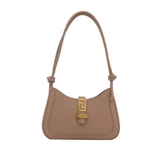 Minimalist beige half-moon shoulder bag with Greek fret gold hardware and knotted strap