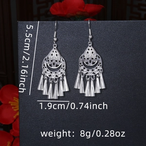 Detail view showing size measurements of ethnic hollow flower tassel earrings in silver