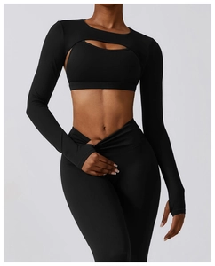 Detail view of black yoga set featuring V-shaped cross waist and thumbhole sleeve cutouts