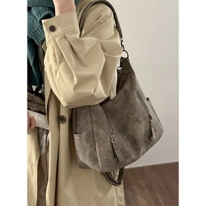 Vintage dark gray soft leather tote bag with double zipper design shown on model shoulder