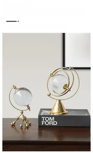 Detail of luxury Nordic gold iron ornaments with crystal glass spheres on wooden desk
