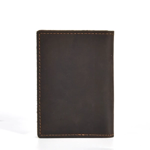 Detail of dark brown crazy horse leather wallet with orange contrast stitching on white background