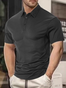 Close-up of three-button placket and collar on black men's polo shirt with textured fabric