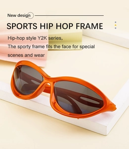 Detail of orange Y2K sports sunglasses with dark lenses on geometric props