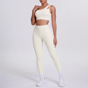 One-shoulder yoga sports bra and high-waist leggings set in creamy white fabric