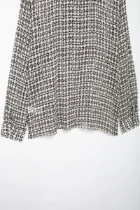Detail shot of sheer chiffon fabric featuring classic black and white polka dot pattern