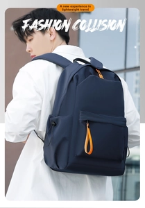 Detail of waterproof navy oxford backpack with orange zippers and side drawstring pocket
