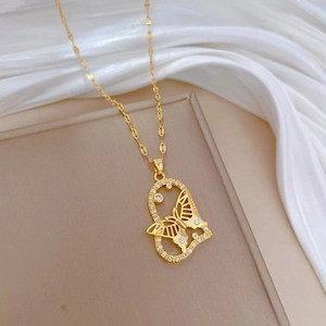 Luxurious gold butterfly pearl necklace with sparkling crystals on silk background