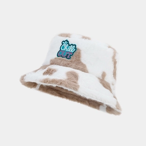 Detailed view of plush cow print bucket hat with Chill OUT embroidered patch