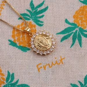 Gold plated pendant necklace with Virgin Mary relief and clear cubic zirconia frame