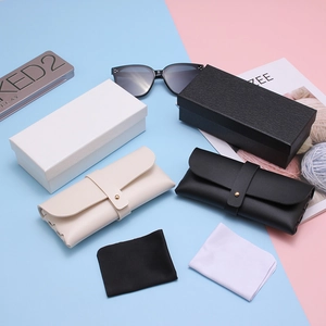Chic eyewear set with oversized sunglasses, faux leather pouches, and hard cases