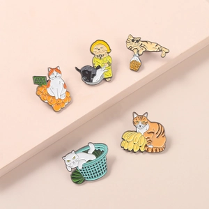 Set of five cute cartoon cat enamel pins featuring fruit and food themes on display