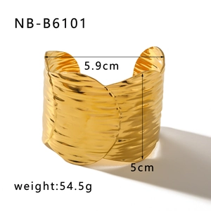 Detail showing the hammered texture and wave-like edges of the wide 14K gold plated cuff