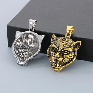 Macro shot showing front and back details of the three-eyed leopard pendant in gold and silver