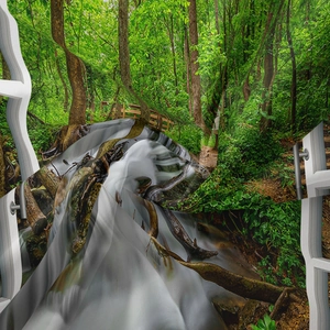Detail view of polyester tapestry fabric showing vivid green forest and waterfall print