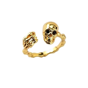 Macro shot of gold skeleton hand holding a skull on an adjustable S925 sterling silver ring