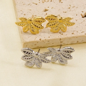 Leaf shaped 14K gold and silver stainless steel studs shown from a 45-degree angle
