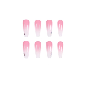 Detail of pink gradient long coffin false nails with sparkling rhinestone accents