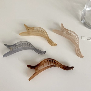 Detail view of colorful matte hair claws in amber, pink, grey and tortoiseshell resin