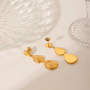 Three-tier teardrop gold earrings with spiral embossed texture in stainless steel