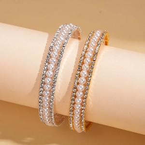 Luxurious layered bracelets with crystals and faux pearls in gold and silver finish