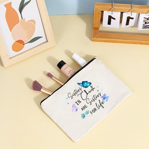 Close-up of canvas storage pouch with butterfly print and Sisters IN Christ text