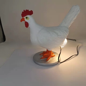 Detail of creative resin chicken night light with red comb and black power cable