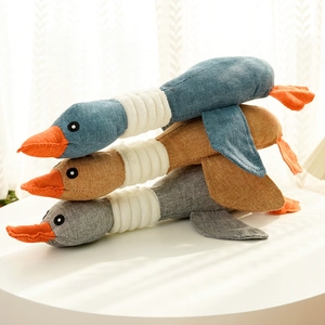 Three plush duck toys in blue, brown, and gray with textured canvas fabric for pets
