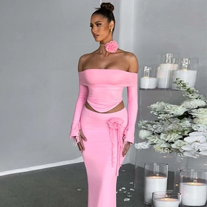 Detail of pink ribbed knit texture with decorative 3D flower choker on two-piece set