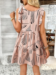 Detail of pink floral dress back with adjustable shoulder ties and layered ruffle hem