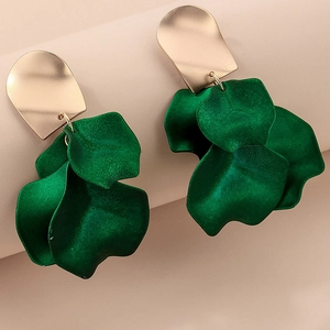 Macro detail of deep green layered flower petals and golden irregular metal earring stud