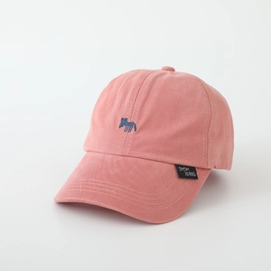 Close-up of pink-orange kids' baseball cap with blue animal embroidery and woven label