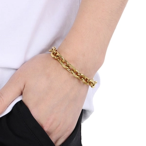 Close-up of high-polished gold Cuban link chain bracelet with modern O-chain metal detail